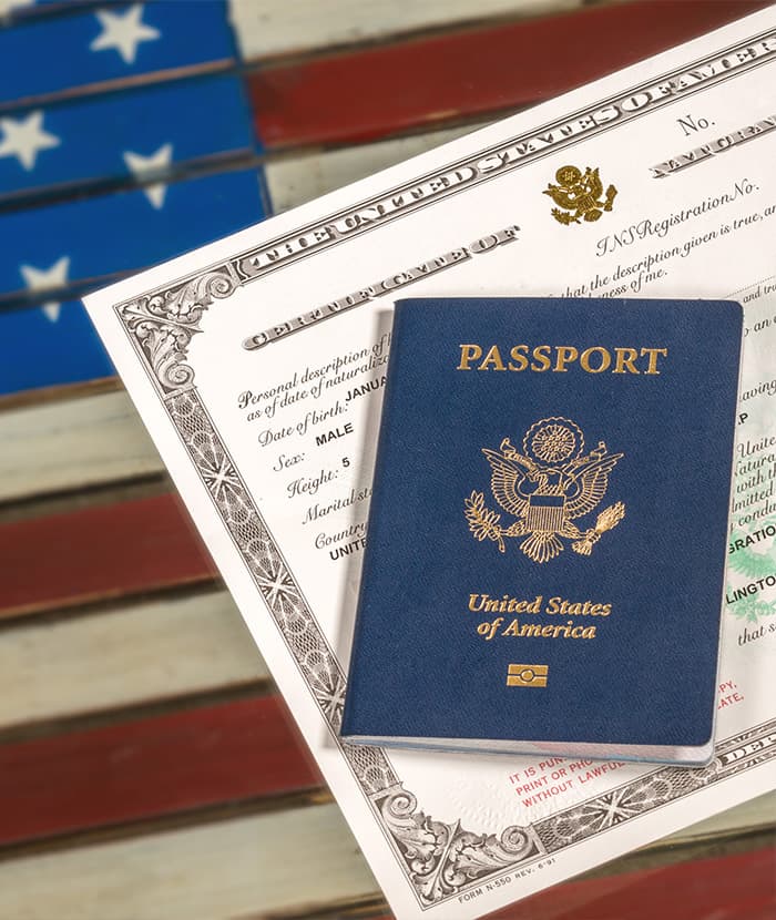 United States passport and birth certificate on a wooden surface, symbolizing immigration and legal documentation.
